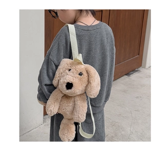 Detail of cute plush dog backpack with adjustable straps on child model back