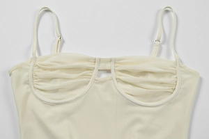 Detail of beige corset dress with pleated mesh, underwire support and adjustable straps