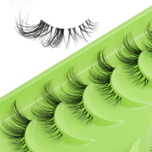 Close-up of 10 pairs of natural dense half lashes on a green tray with detailed lash curve