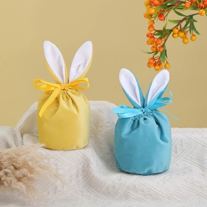Detailed view of yellow and blue velvet Easter bunny ear gift bags with drawstring closure