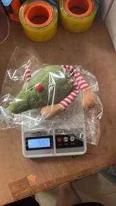 Weight measurement of cute plush Christmas mouse doll showing 54.1 grams on a scale