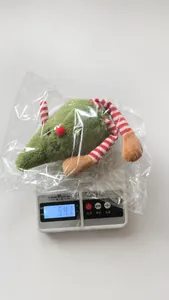 Weight measurement of cute plush Christmas mouse doll showing 54.1 grams on a scale
