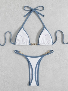 Detail of blue bikini top with golden metal chain rings and ribbed fabric texture