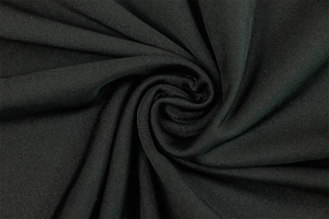 Close-up of black textured fabric showing intricate spiral ruching and soft drape texture