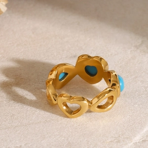 Gold stainless steel heart-shaped hollow ring with blue turquoise inlay from a top view