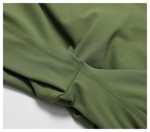 Macro view of olive green yoga pants featuring premium flatlock stitching and knit fabric