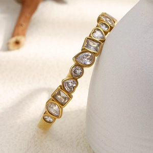 Detail of 18K gold plated bangle with heart, square, and teardrop zircon settings