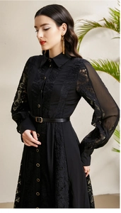 Close-up of golden buttons and intricate vintage embroidery on black lace sleeves dress