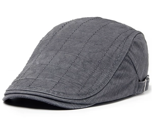 Detail of gray cotton flat cap featuring decorative wave stitching and metal adjustment buckle