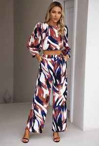 Detailed view of women's two-piece set featuring brown and blue abstract printed fabric