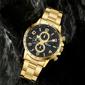 Men's gold steel chronograph watch with black dial on textured rock background