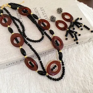 Vintage crystal oval tassel necklace and earrings set with amber-red beads and gold accents