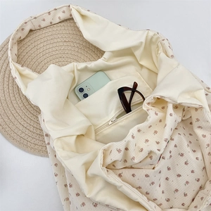 Interior view of corduroy tote bag showing spacious pockets for phone and glasses