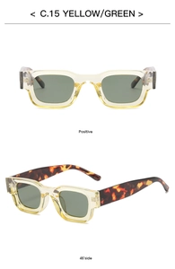Detail of square vintage sunglasses with yellow transparent frames and green lenses