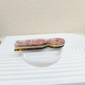 Close-up of multicolored tortoiseshell acetate U-shaped hair forks with marble texture