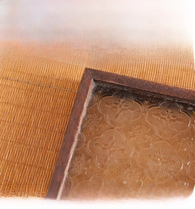 Close-up of vintage walnut wood corner and textured begonias glass of the tea tray