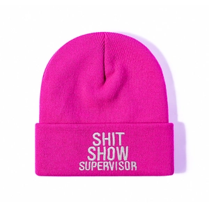 Rose pink knit beanie with white Shit Show Supervisor embroidery on a cuffed edge