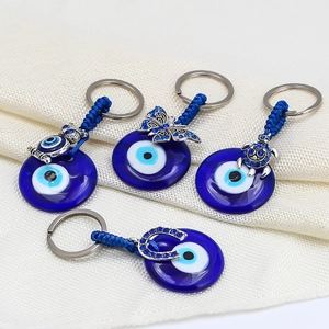 Detailed view of evil eye keychains featuring owl, butterfly, turtle and horseshoe charms