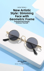 Close-up of retro round sunglasses with gold geometric frames and dark black lenses