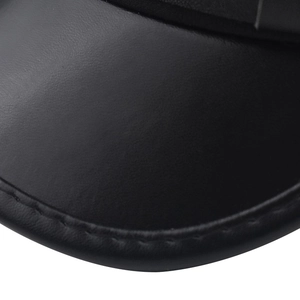 Detailed close-up of black leather military cap brim showing fine texture and neat stitching