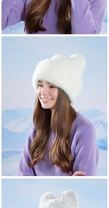 Detailed view of white faux fur winter hat with cute ears on snowy background