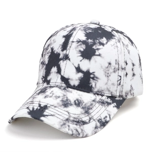 Detail of a black and white tie-dye baseball cap with curved brim and reinforced stitching