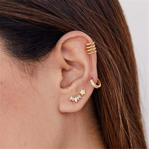 Close-up of a gold S925 sterling silver ear jewelry set with crown and star studs