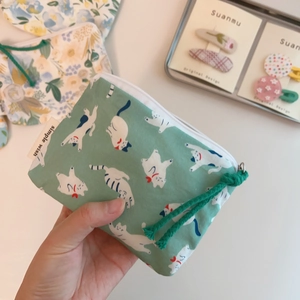 Mint green floral cotton coin purse with white cat print and zipper closure in hand