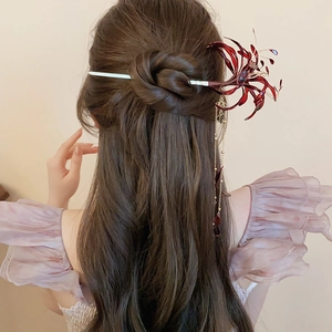 Detailed view of Lycoris radiata hair pin with elegant tassels on a dark hair bun