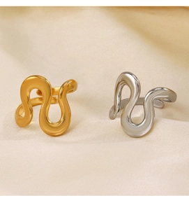 Detailed view of wave-shaped irregular rings in gold and silver on soft knit fabric