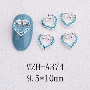 Detail of 9.5x10mm light blue rhinestone hollow heart and bow nail art charms