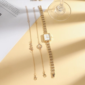 Elegant gold square watch set with delicate LOVE bracelets on a decorative background
