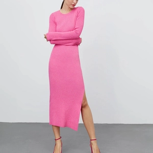 Detailed view of the side slit and ribbed texture on this pink long sleeve knit dress
