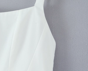 Close-up of white dress bodice with high-quality fabric texture and neat stitching