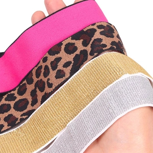 Close-up of elastic wig bands in leopard print, rose red, and metallic gold-silver textures