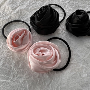 Elegant satin rose hair ties in pink and black colors, 4-piece set on white background
