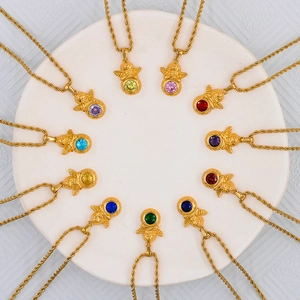 Set of twelve vintage gold angel necklaces with colorful birthstone zircons on rope chains