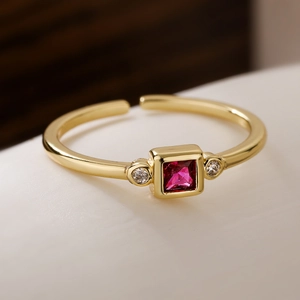 Gold plated geometric open ring featuring a square red gemstone and white zircon accents