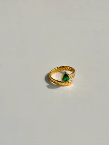 Macro shot of 18k gold plated spiral ring featuring a green pear-cut zircon stone