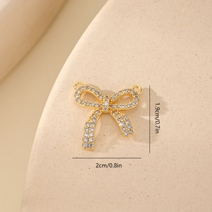 Macro shot of cubic zirconia bow pendant showing precise 2cm by 1.9cm dimensions