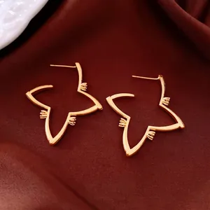 18K gold plated star-shaped hoop earrings with hollow design on red velvet background