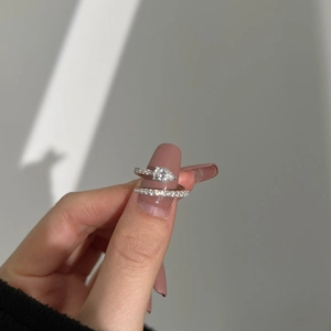 Macro shot of silver ring featuring pear-cut zircon and pave-set diamond detail