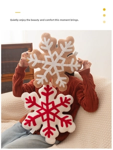 Close-up of soft snowflake plush pillows in brown and white with cozy textures