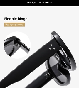 Detail of flexible hinges and signature metal dots on black oval sunglasses frame
