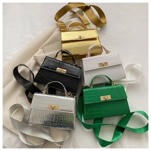 Close-up of small crossbody bags in five colors with crocodile texture and metal locks