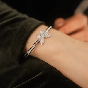 Detail shot of silver butterfly cuff bracelet with pavé cubic zirconia on model