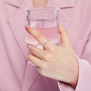 Close-up of S925 sterling silver ring with pink cubic zirconia on a model's finger