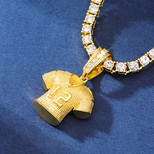Macro shot of gold jersey pendant with number 12 and rhinestone chain details
