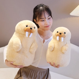 Two cute beige seal plush toys in different sizes held by a person in a cozy room