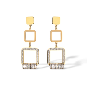 Detail view of geometric gold earrings with cubic zirconia charms and square links